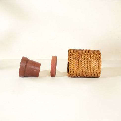 Rattan plant pot with terracotta insert and saucer lifestyle