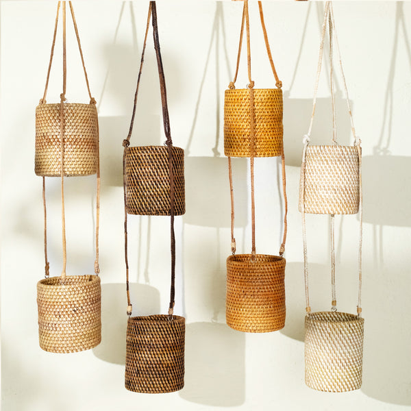 Set of rattan hanging planters in multiple finishes including natural, dark brown, honey and white wash