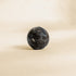 Black marble ball on a beige background cable organisation