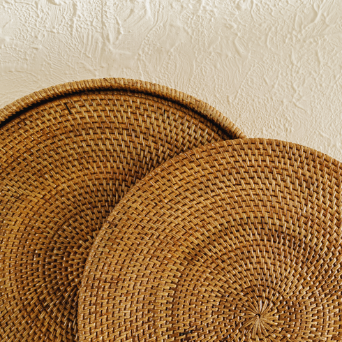 Honey brown round rattan placemats with holder close up