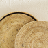 Natural round rattan placemats with holder close up