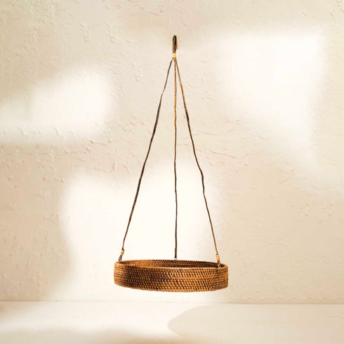 Woven hanging basket on a neutral background