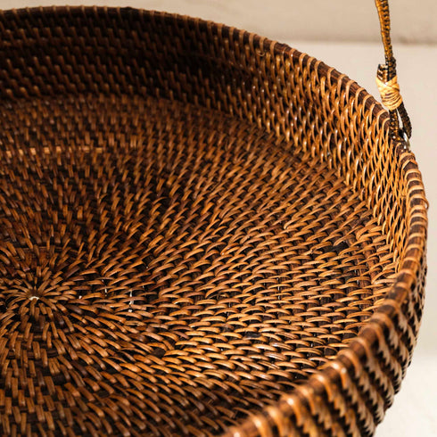 Close-up of a woven wicker basket on a white background