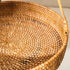 Close-up of a woven basket with a handle on a light background