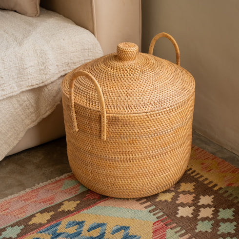 Rattan basket with lid and handles for storage by sofa
