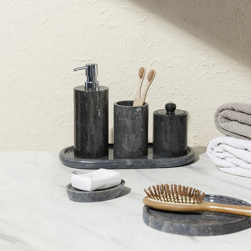Black marble bathroom accessories set on counter