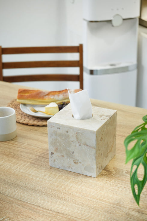 Beige tissue box on table in marble