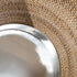 Close-up of handwoven rattan planter with removable metal liner insert for indoor plant use