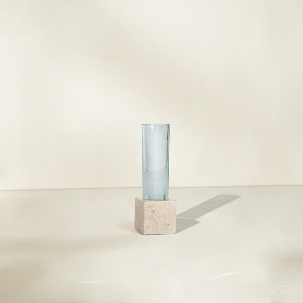 Single marble propagation vase with one clear glass test tube on a neutral surface